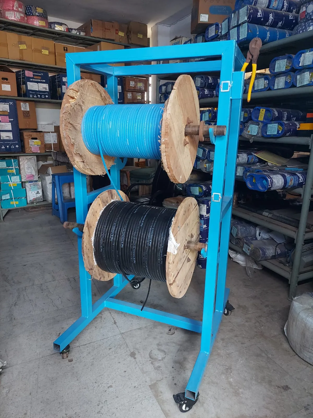 Blue cable drum trolley loaded with cable drums